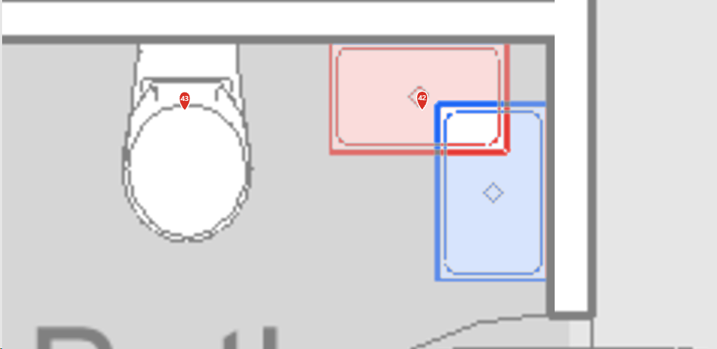 Two versions of a bathroom plan overlaid in AECOtwin: a fixture's old position outlined in red and its new position in blue, with issue pins 42 and 43 on the sheet.